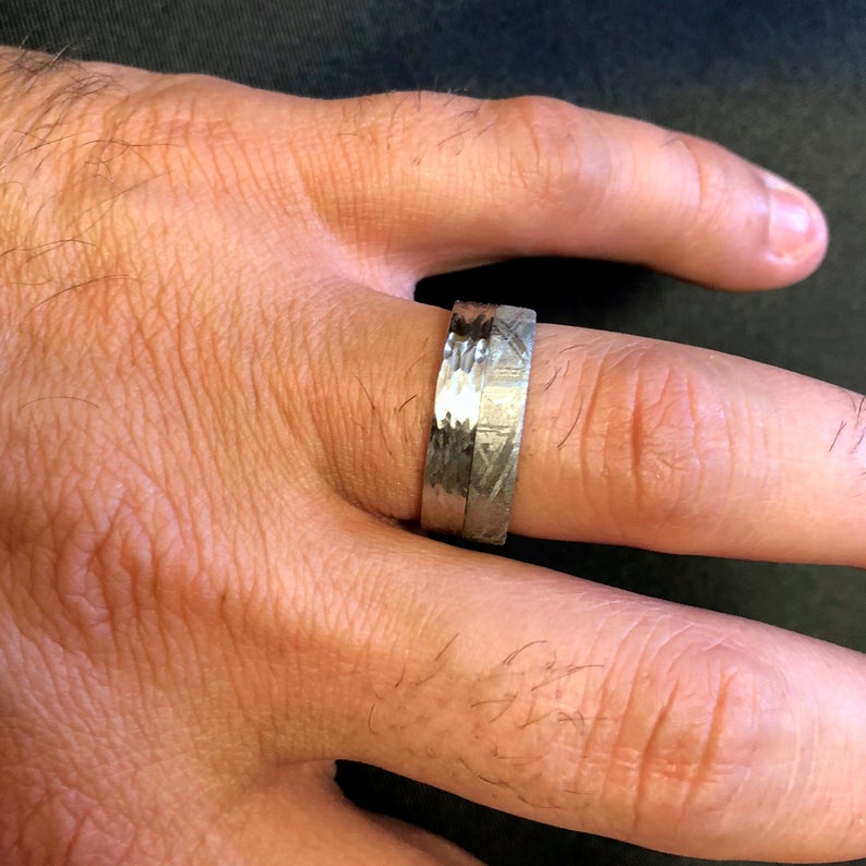 8mm wide men&#39;s wedding band with half Gibeon meteorite and half tree bark finished cobalt on man&#39;s hand