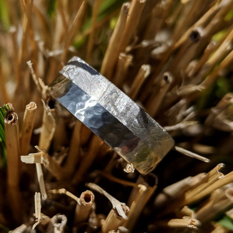 8mm wide cobalt and meteorite wedding ring with half the band covered in meteorite and the other half with hammered polished cobalt