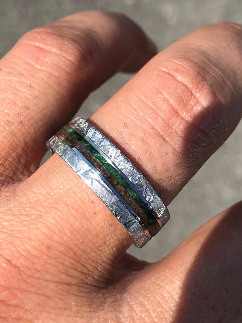 8mm wide flat profile meteorite ring with dinosaur bone and green box elder wood burl on man&#39;s hand