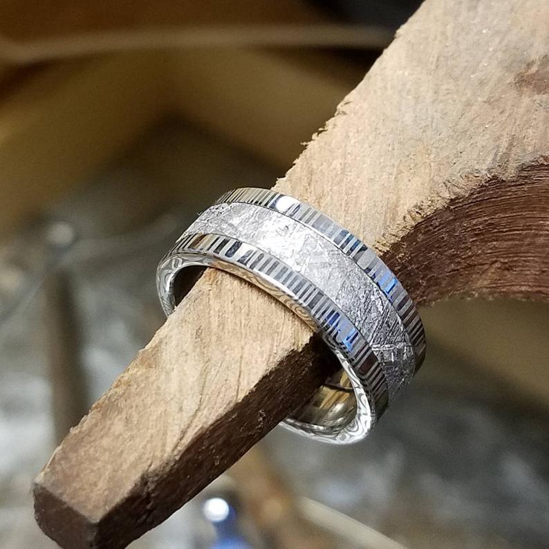 8mm wide Gibeon meteorite wedding band with Damascus steel edges and sleeve
