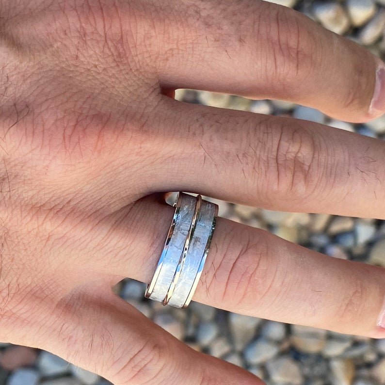 10mm wide Gibeon meteorite wedding band with twisted white gold inlay on man&#39;s hand