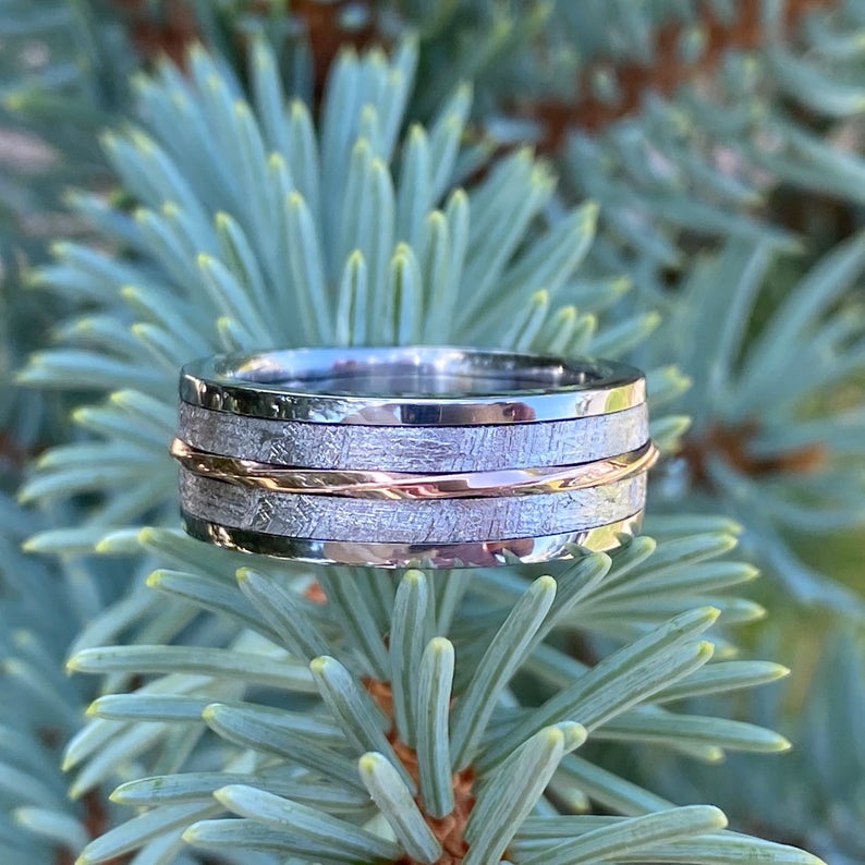 7mm wide men's meteorite ring with a twisted center rose gold inlay with titanium edges and sleeve