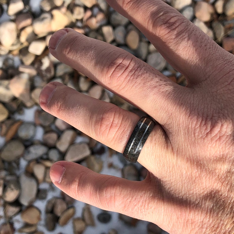 8mm wide stardust ring with two titanium inlayed lines and sleeve on man&#39;s hand