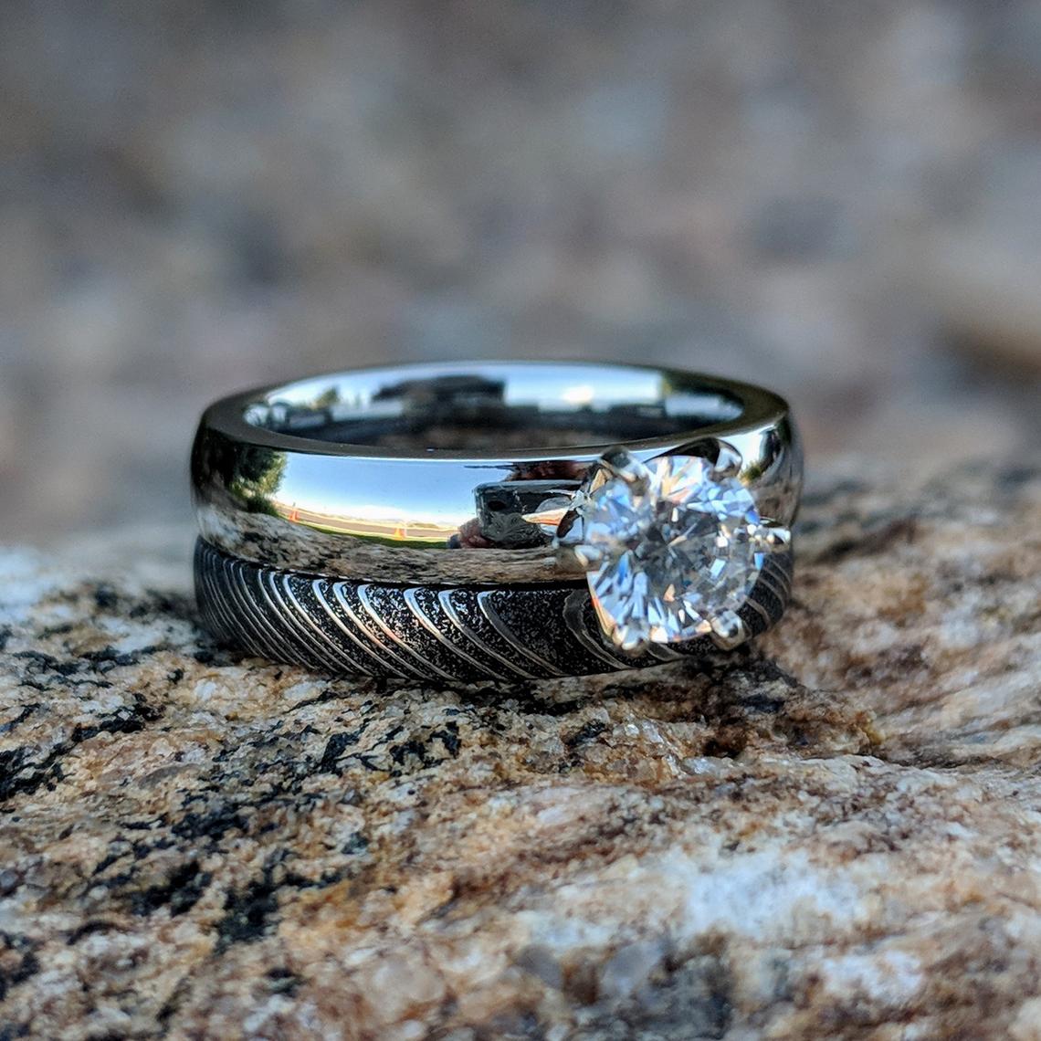 4mm wide cobalt engagement ring with a .5 carat cubic zirconia stone and a 3mm wide black Damascus steel band