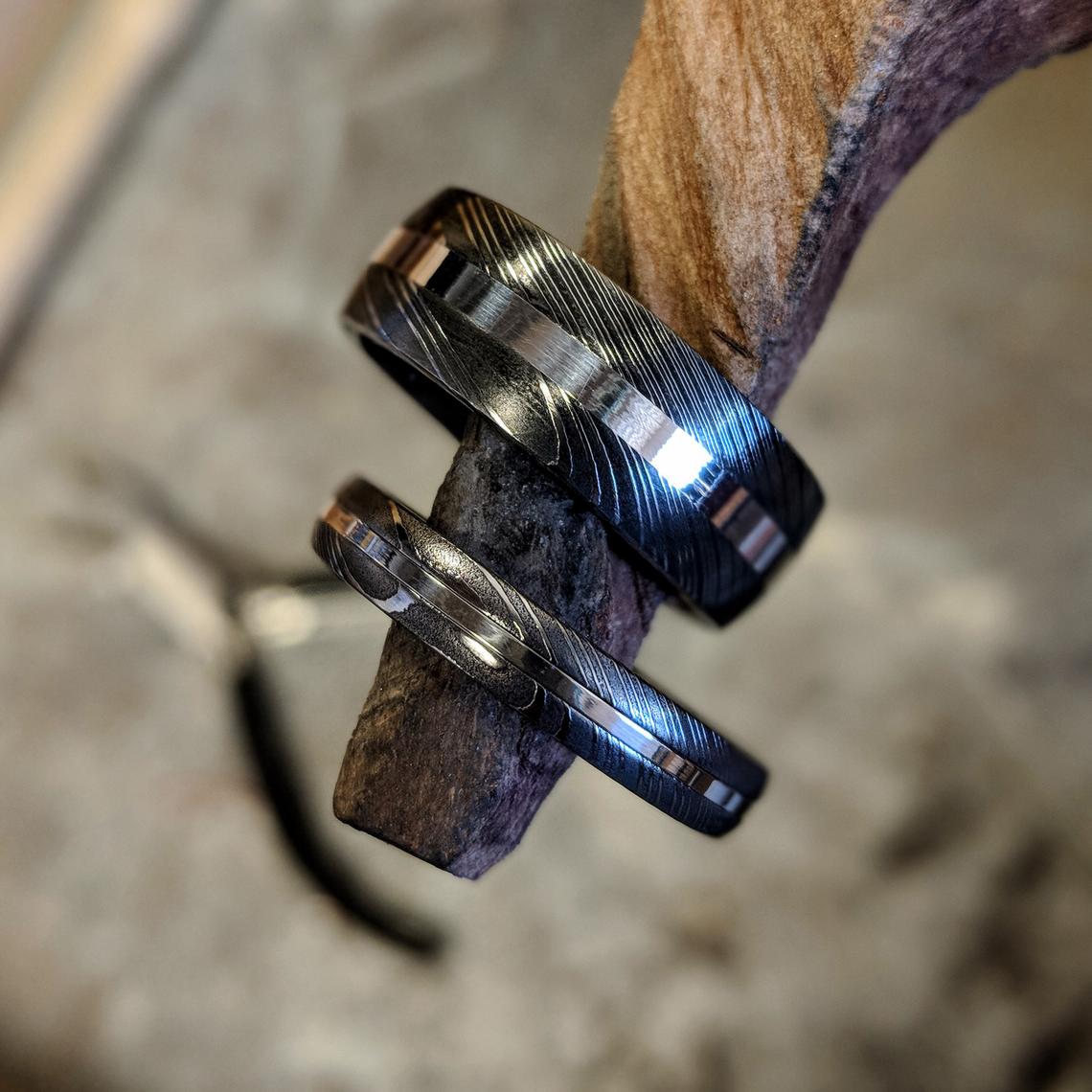 8mm wide and 4mm wide Damascus steel wedding ring set with centered sterling silver inlay