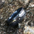 8mm wide Black Damascus steel ring with a white gold inlay and a blue and black cobaltium mokume sleeve