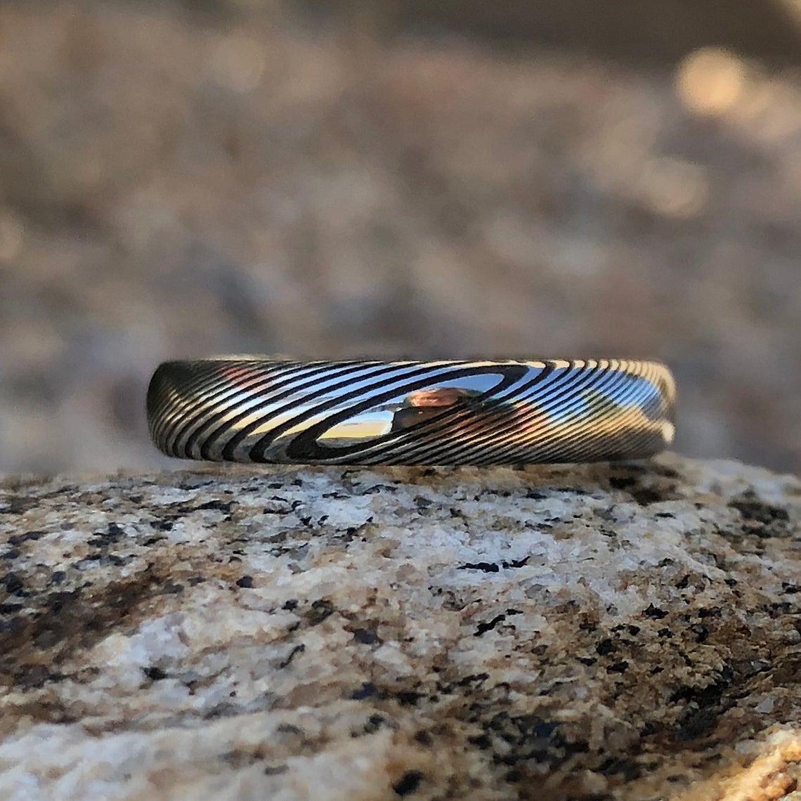 4mm wide Damascus steel wedding band with a rounded profile