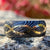 8mm wide Black Damascus steel ring with a 14k yellow gold infinity inlay