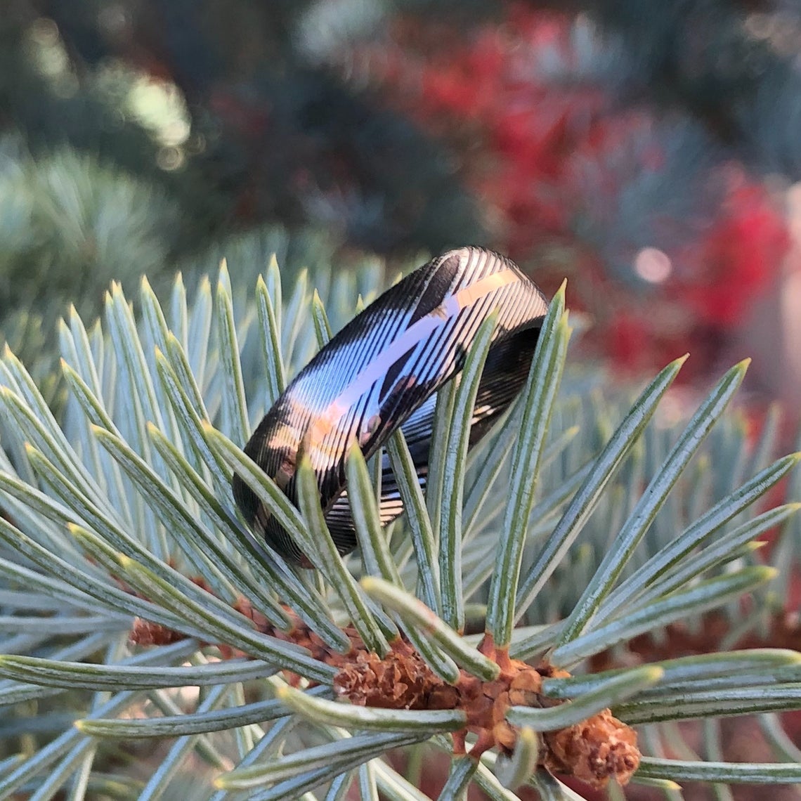 7mm wide Damascus steel ring with a centered rose gold inlay