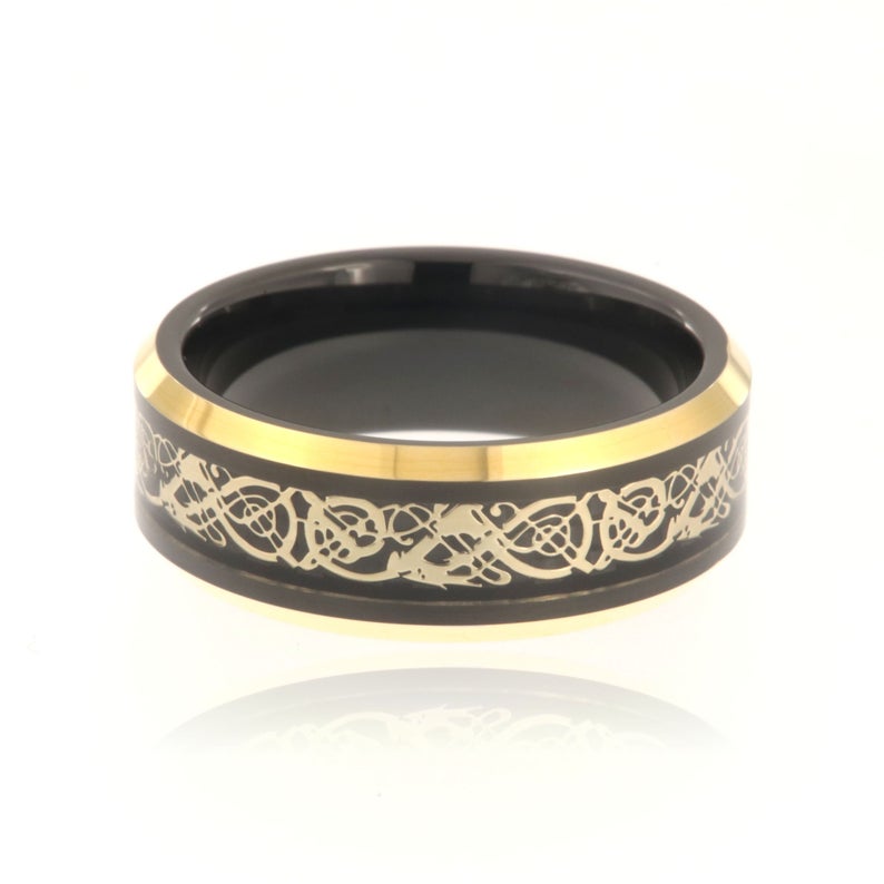 8mm wide black tungsten ring with a gold Celtic earth design
