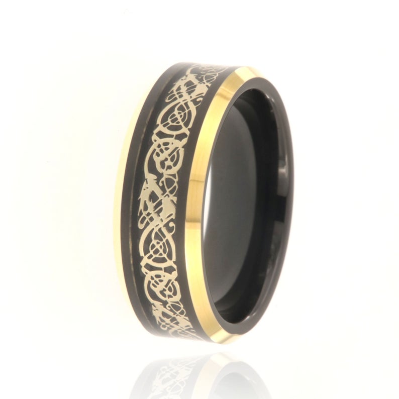 8mm wide black tungsten ring with a gold Celtic earth design